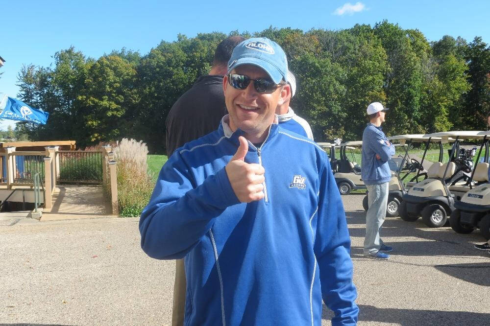Man at a golf course in GVSU sweatshirt